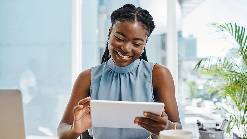 woman holding a tablet smiling