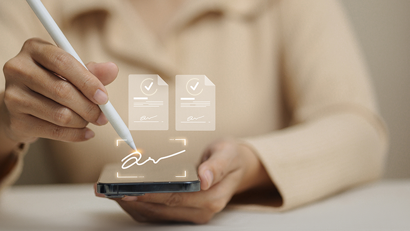 Hands with a phone, stylus and signatures
