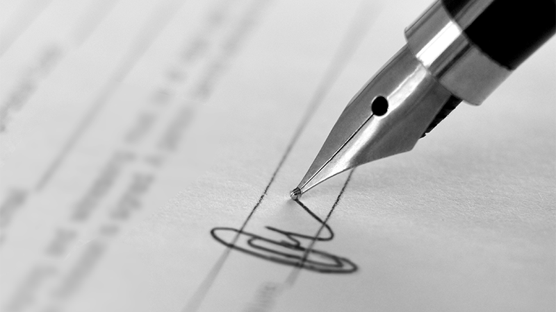 Ink pen on paper signing